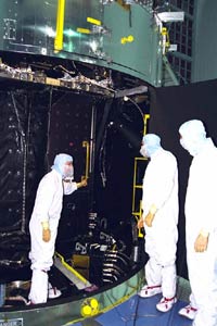 A group of astronauts are training with a realistic Hubble model for the upcoming tasks.